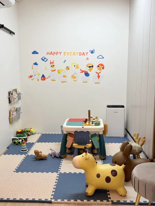 The play corner at the clinic, with a soft mat, a low table and toys